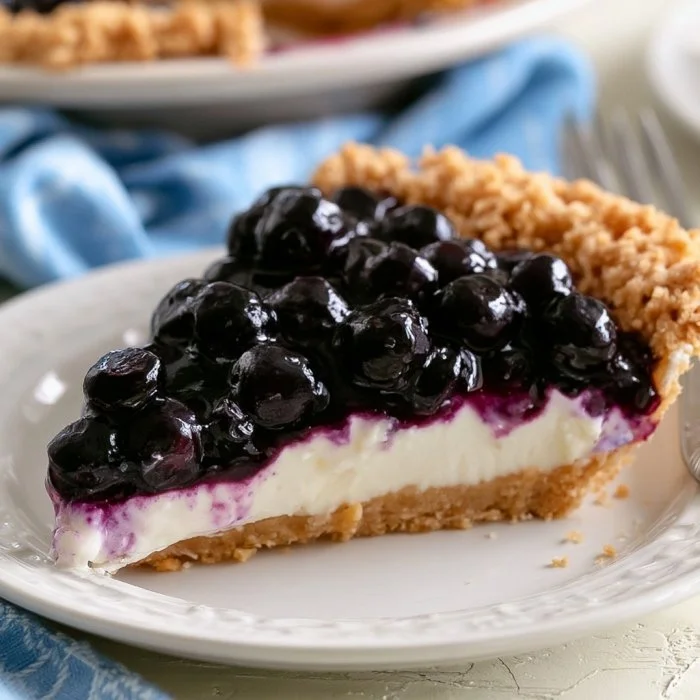 Delicious homemade blueberry cream pie with a smooth filling and fresh blueberries on top